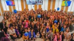 Fotografía grupal de participantes del Unstereotype Alliance Summit LATAM 2026, convocado por ONU Mujeres en la Universidad Torcuato Di Tella. Las personas posan con credenciales naranjas y globos que representan el planeta.